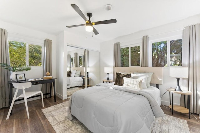 bedroom with a closet, baseboards, and wood finished floors