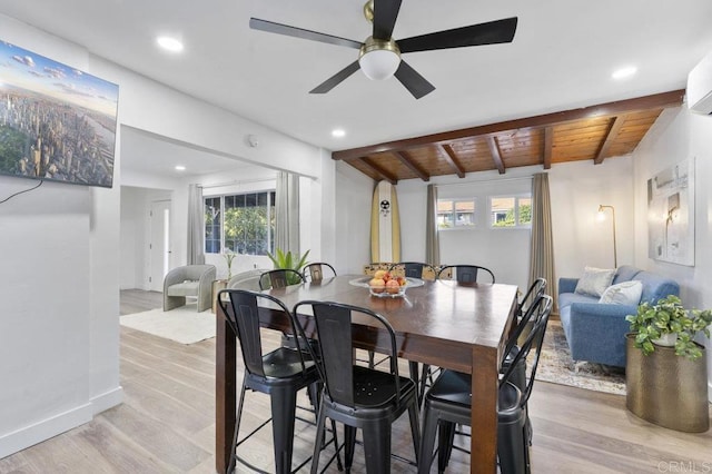 dining area featuring beam ceiling, recessed lighting, light wood-style floors, wooden ceiling, and baseboards