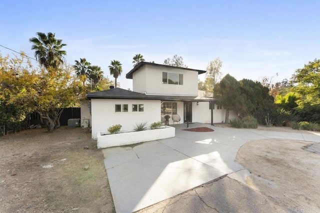 view of front of house featuring cooling unit and stucco siding