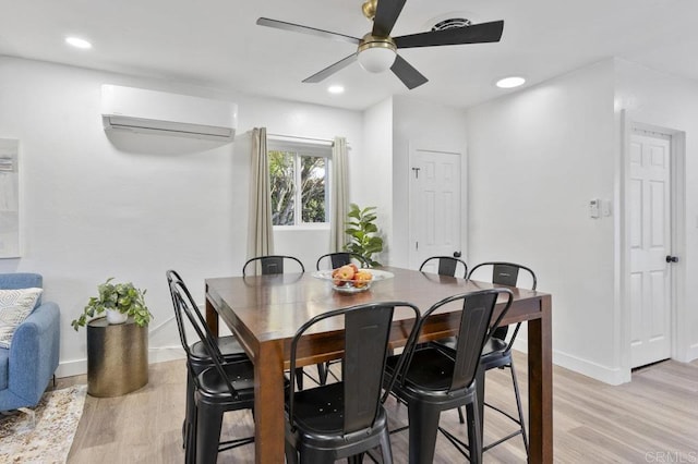 dining space with light wood-style floors, recessed lighting, baseboards, and a wall mounted AC