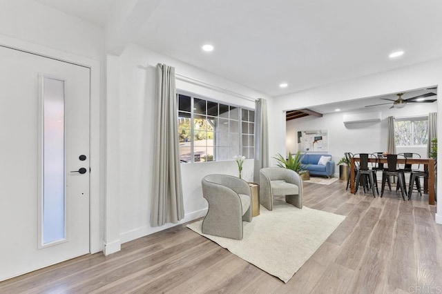 sitting room with recessed lighting, a healthy amount of sunlight, and wood finished floors