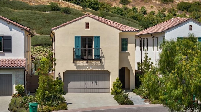 mediterranean / spanish home with a balcony and a garage