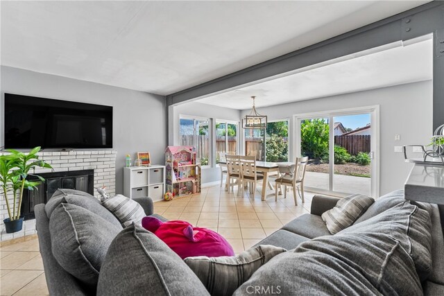 living area with a fireplace and light tile patterned floors