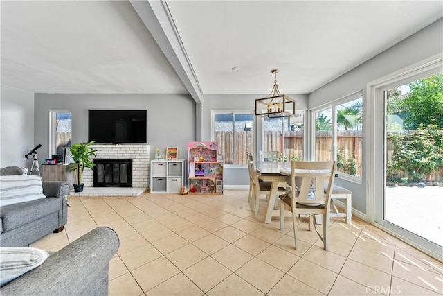 interior space featuring light tile patterned floors, a fireplace, and baseboards