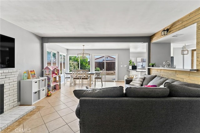 living area with a fireplace and light tile patterned floors