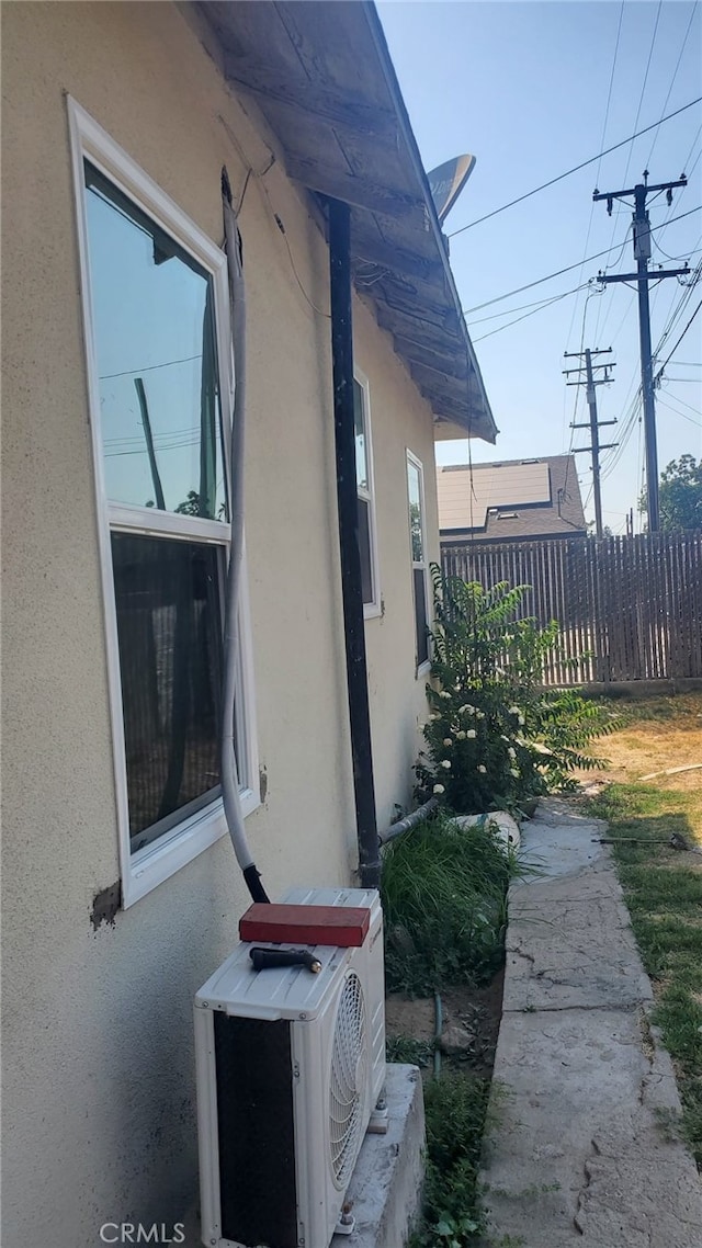 view of side of home with ac unit