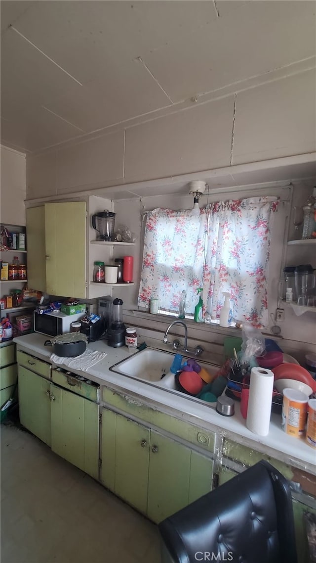 kitchen featuring green cabinets and sink