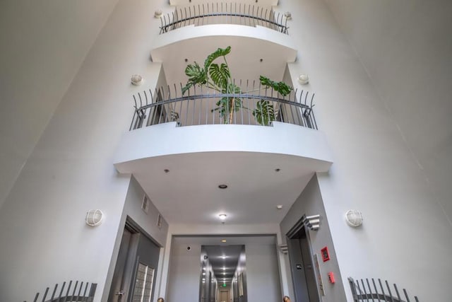 staircase with a towering ceiling