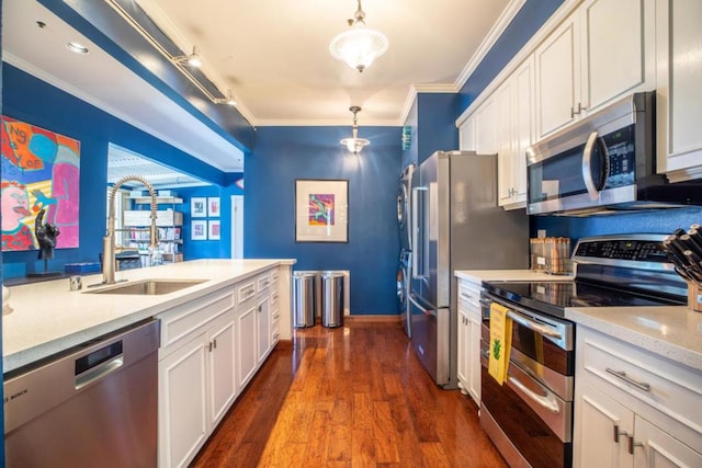 kitchen with pendant lighting, white cabinetry, and appliances with stainless steel finishes