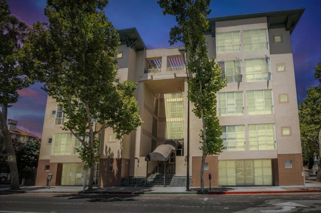 view of outdoor building at dusk