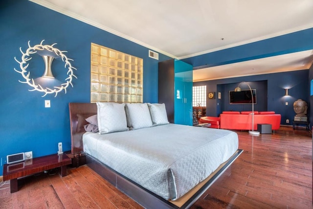 bedroom with dark wood-type flooring and ornamental molding