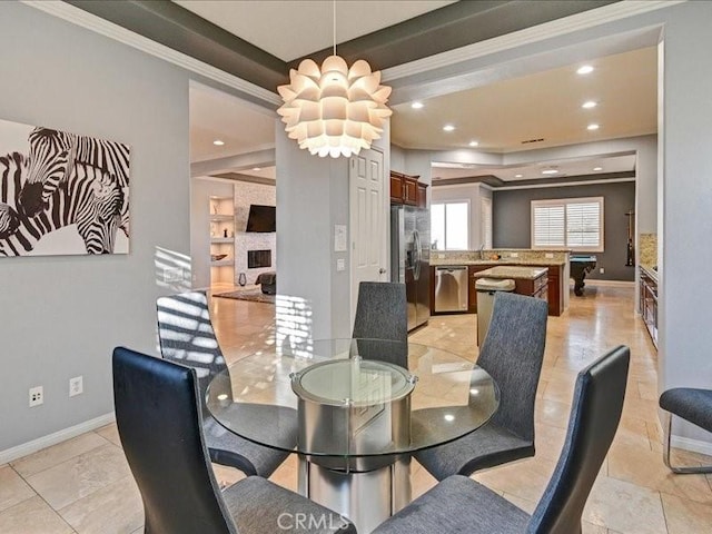 dining room featuring a stone fireplace