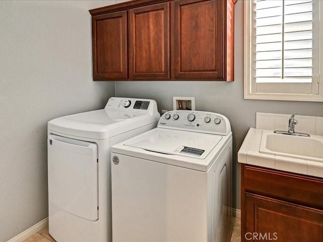 laundry area with cabinets, sink, and washer and dryer