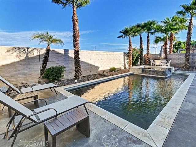 view of swimming pool with an in ground hot tub