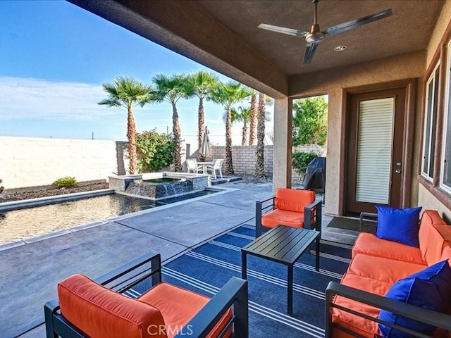 view of patio with outdoor lounge area, ceiling fan, and an in ground hot tub