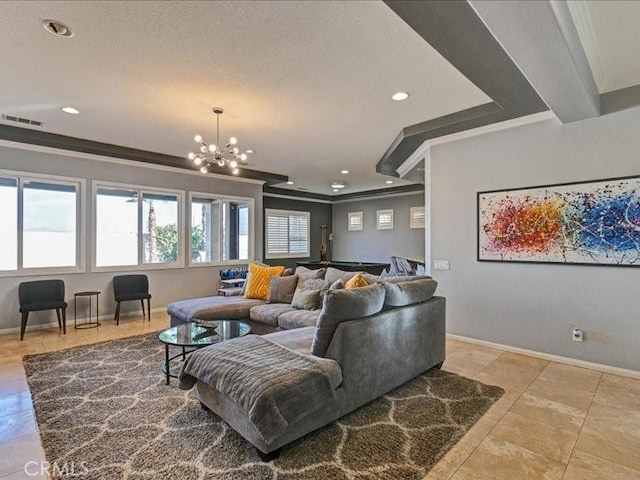 living room with an inviting chandelier and crown molding