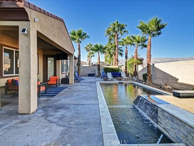 view of swimming pool with pool water feature and a patio area