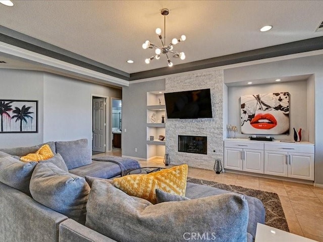 tiled living room featuring an inviting chandelier, a stone fireplace, built in features, and a textured ceiling