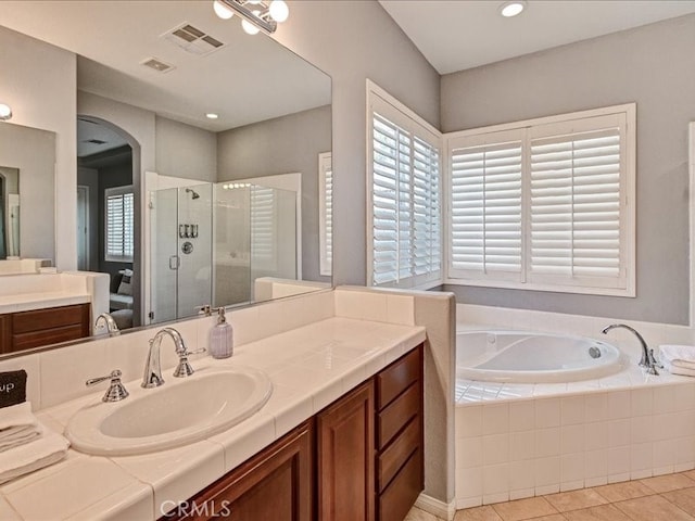 bathroom featuring tile patterned flooring, vanity, and independent shower and bath