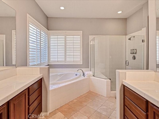 bathroom with vanity, tile patterned floors, and separate shower and tub