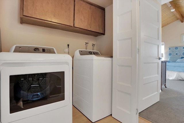 laundry room with independent washer and dryer, wooden ceiling, and cabinets