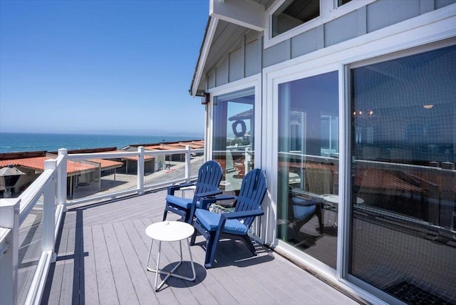 wooden terrace with a balcony and a water view