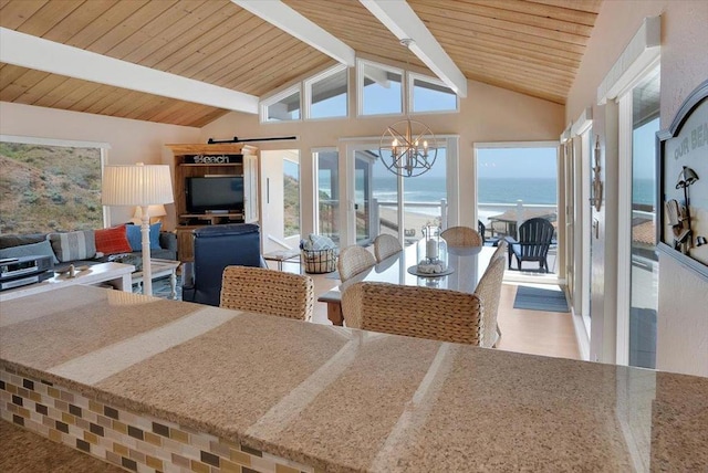 dining area with wood ceiling, beamed ceiling, a barn door, an inviting chandelier, and high vaulted ceiling