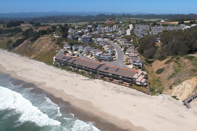 birds eye view of property with a water view and a view of the beach