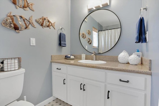 bathroom featuring vanity, toilet, and walk in shower