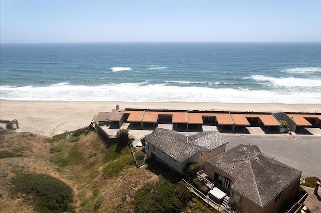 birds eye view of property with a water view and a view of the beach