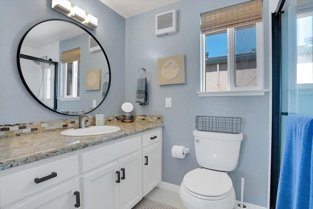 bathroom featuring toilet, vanity, and tile patterned flooring