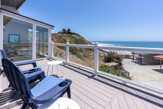 deck featuring a water view and a view of the beach