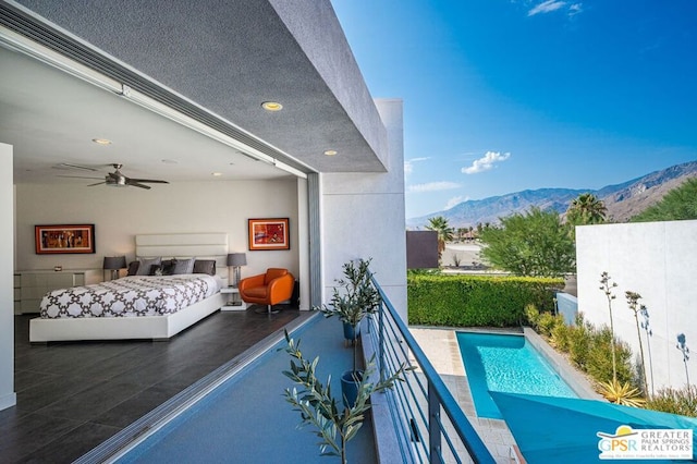 exterior space featuring a mountain view and ceiling fan