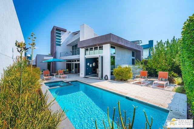 view of swimming pool with a patio area and an in ground hot tub