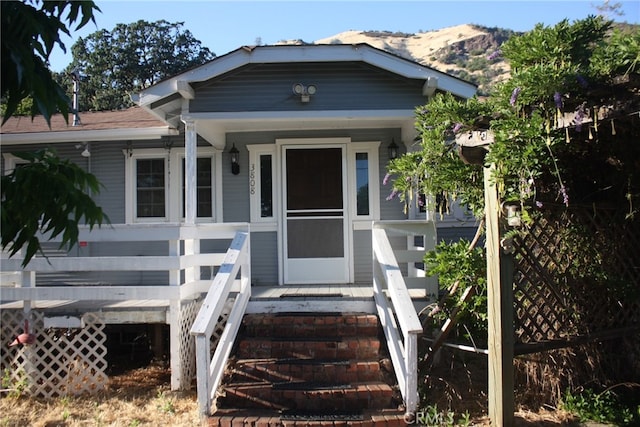 property entrance with a porch and a mountain view