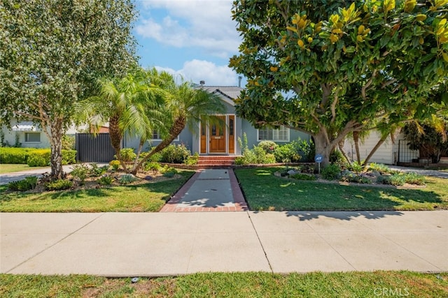 view of property hidden behind natural elements with a front lawn