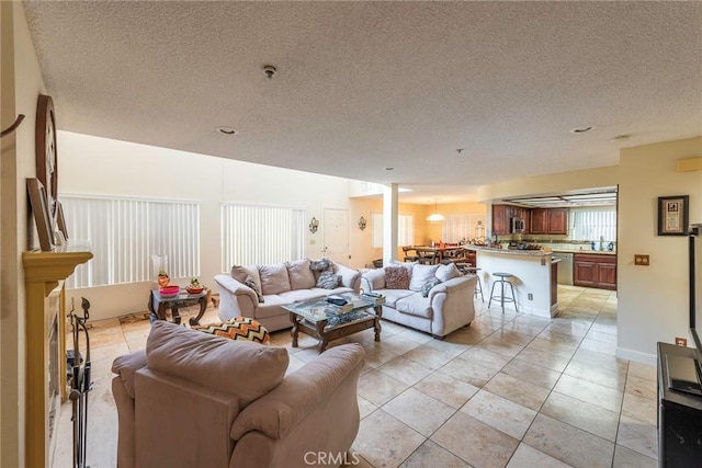 tiled living room with sink and a textured ceiling