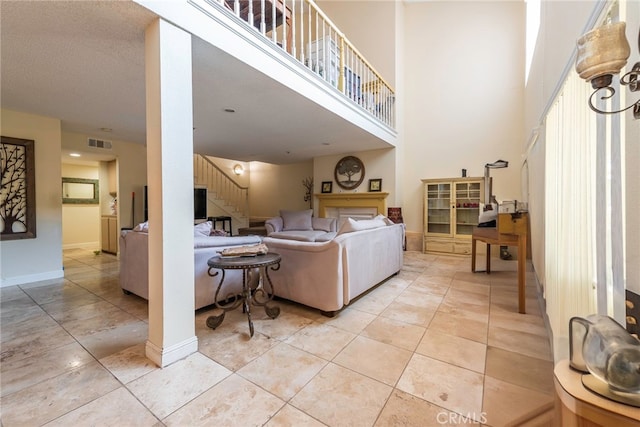 tiled living room featuring a high ceiling