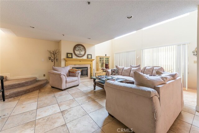 living room featuring light tile patterned floors and a textured ceiling