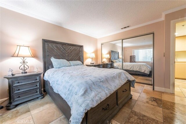 bedroom featuring ornamental molding, a closet, and a textured ceiling