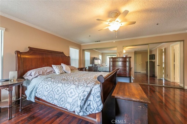 bedroom featuring a textured ceiling, ornamental molding, dark hardwood / wood-style floors, and ceiling fan