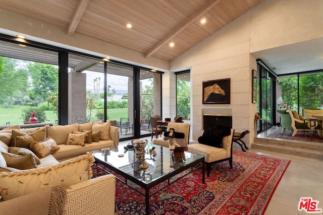 living room with a tile fireplace, high vaulted ceiling, concrete floors, wood ceiling, and beam ceiling