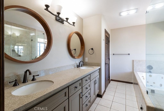 bathroom with vanity, tiled tub, and tile patterned flooring