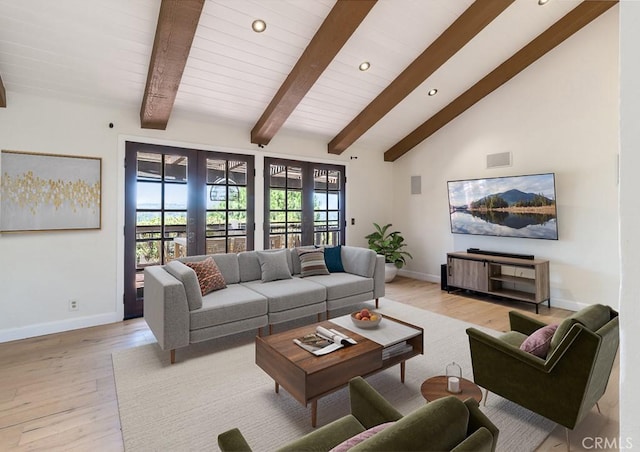 living room with high vaulted ceiling, french doors, and light wood-type flooring