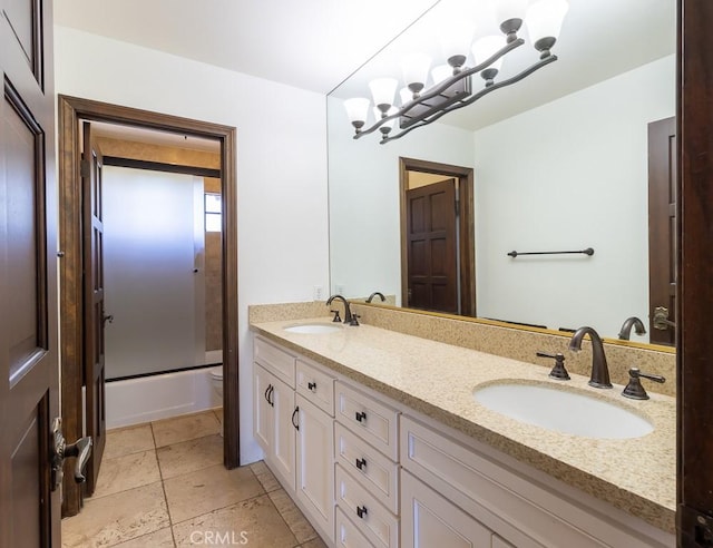 full bathroom featuring bath / shower combo with glass door, vanity, and toilet