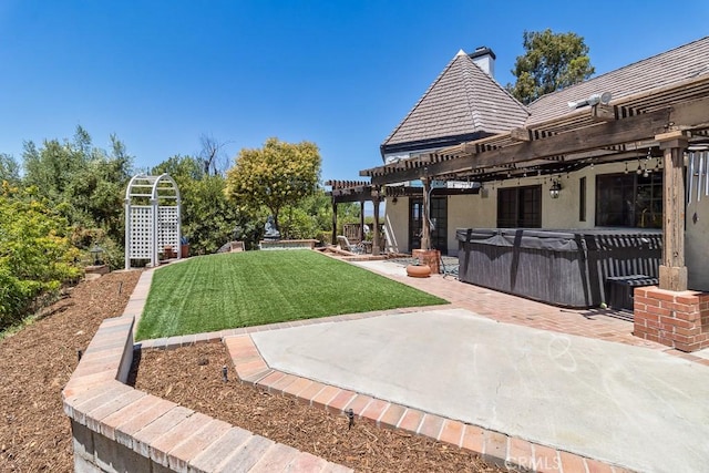 view of yard with a hot tub, a pergola, and a patio area