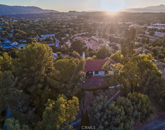 aerial view at dusk featuring a mountain view