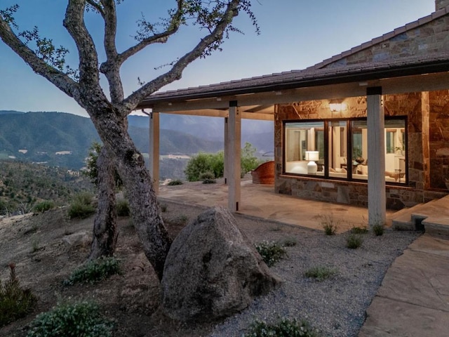 exterior space featuring a patio area and a mountain view