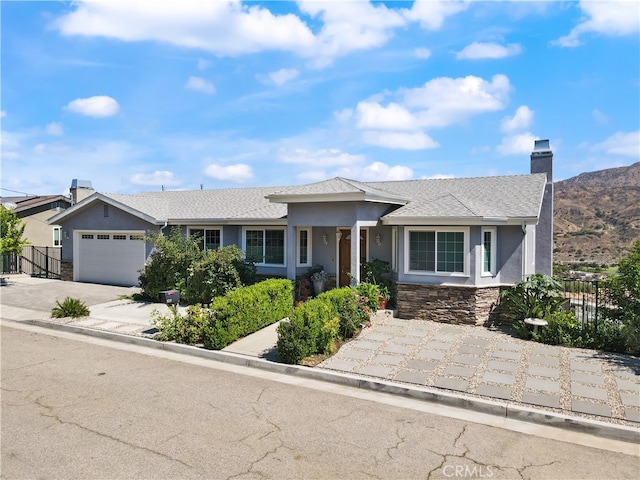 view of front of property featuring a mountain view and a garage