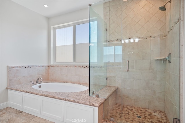 bathroom featuring independent shower and bath and tile patterned flooring